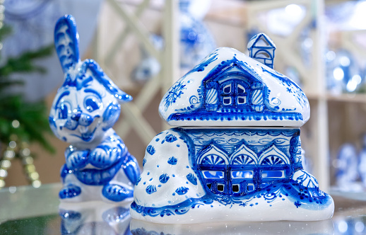 Porcelain snow-covered hut in the style of Russian Gzhel.