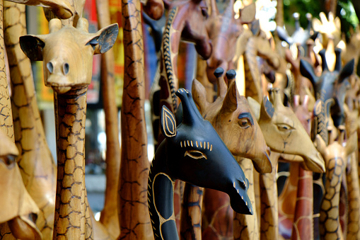 Wooden statues of giraffes on display.