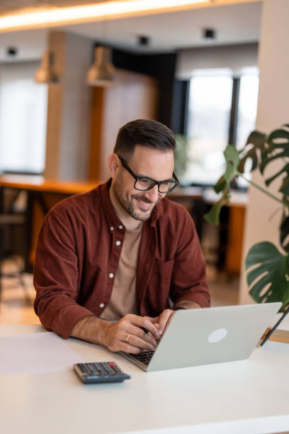 istock Smiling businessman working at home 1451131654