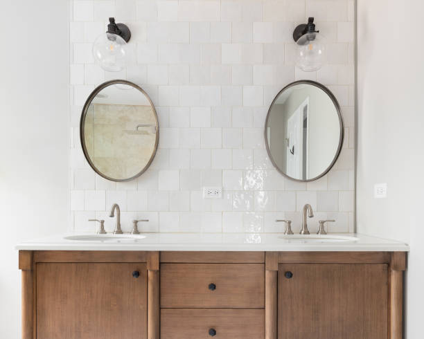 istock A bathroom with a wood cabinet and tiled backsplash. 1451133206