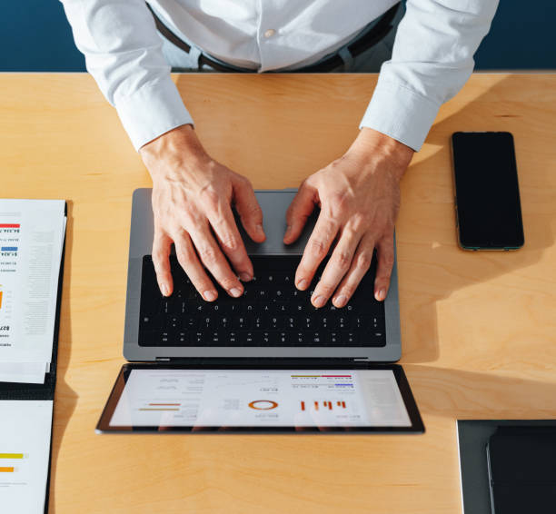 istock Directly Above Photo Of Unrecognizable Businessman Using Laptop Computer At Home 1451134554