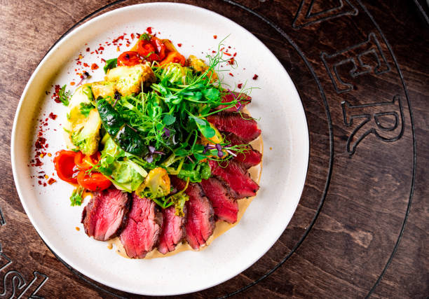 Roast beef salad with vegetables on plate