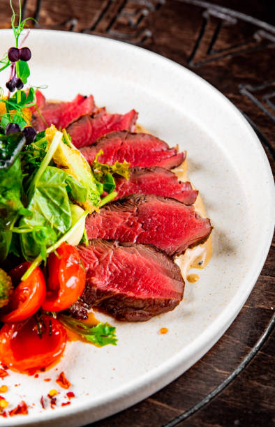 istock Roast beef salad with vegetables on plate 1451136433