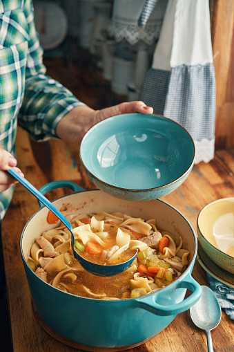 Preparing Chicken Noodles Soup with Fresh Vegetables