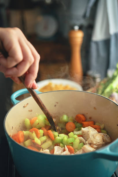 istock Preparing Chicken Noodles Soup with Fresh Vegetables 1451138136