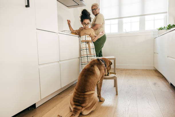 istock Girl and dog in the kitchen 1451140836
