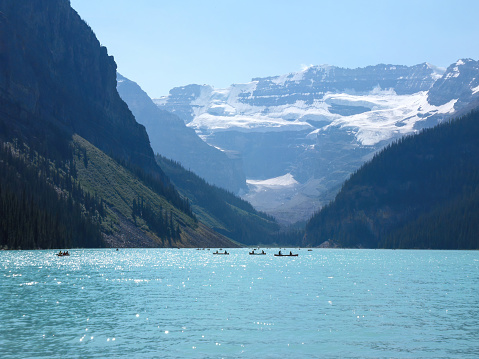 The magnificent Louise Alberta lake and mountain view in canadian nature with people kayaking