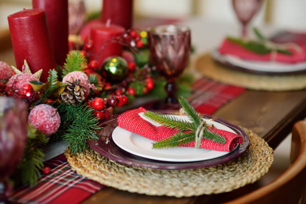 istock Christmas table set with wreath and red candles. Eve Xmas. 1451142705