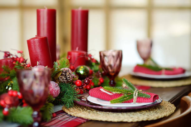 istock Christmas table set with wreath and red candles. Eve Xmas. 1451142768