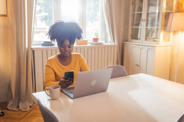 istock Young Afro-american woman working on her laptop 1451146948
