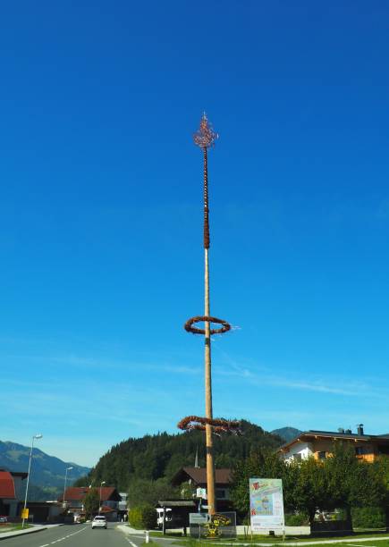Niederndorf, Austria – September 23, 2022: A vertical shot of a Maypole with a blue sky background on a sunny day