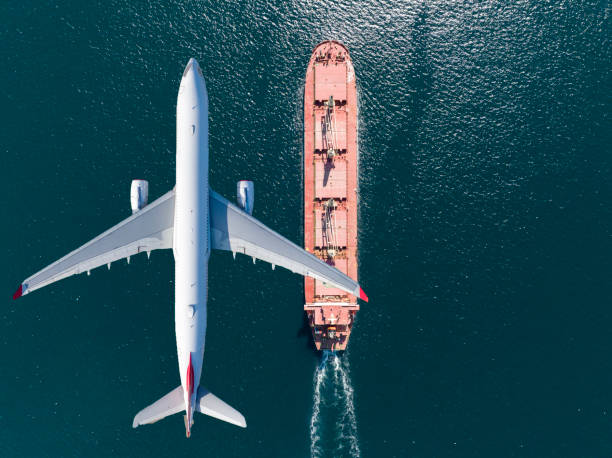 istock Container ship sail through airplane flying on the sea 1451148407