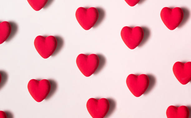 istock Red hearts pattern on pastel light pink background. Modern Valentine's day concept. Creative love idea. 1451148562