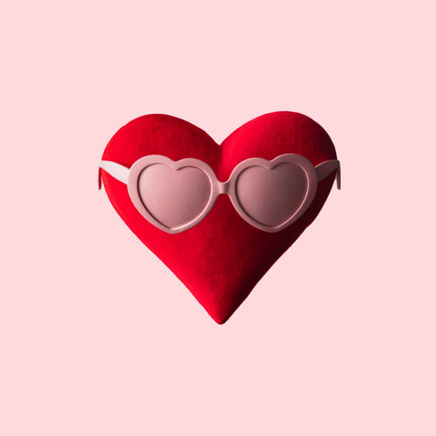 istock Creative romantic love idea. Red heart with heart shaped sunglasses on light pastel pink background. Minimal Valentine's day composition. 1451148663