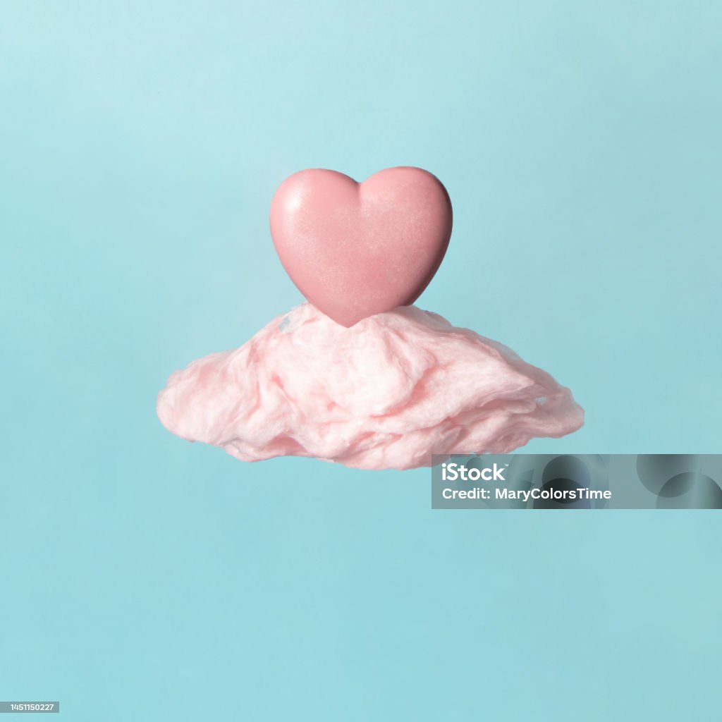 Minimal Valentine's day idea. Light pink heart on pastel cloud. Creative love concept. Seventh heaven composition. Arrangement Stock Photo