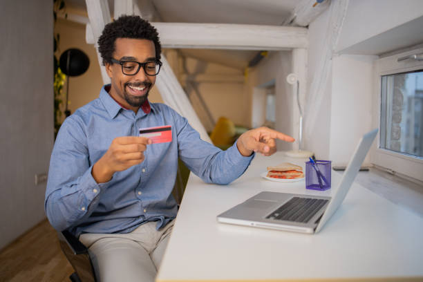 istock Man using her credit card to shop online 1451150276