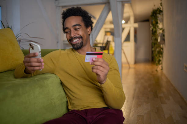 istock Man using her credit card to shop online 1451150307