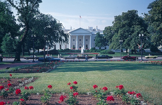 White House in the Spring with Green Grass, Trees, Red Tulips, Fountain and Clear Blue Sky, Washington DC, USA. Canon EF 24-105mm f/4L IS lens.