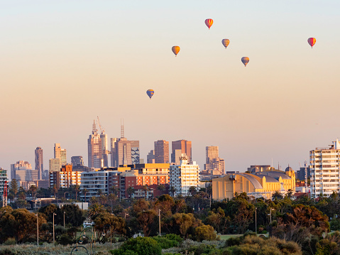 Melbourne skyline at sunrise with hot air balloons