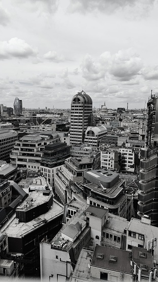 Greyscale image over the roofs of buildings in London city