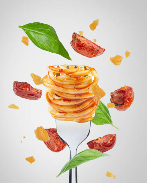 istock Bolognese pasta with tomatoes and cheese. Falling ingredients. Levitation. 1451155205