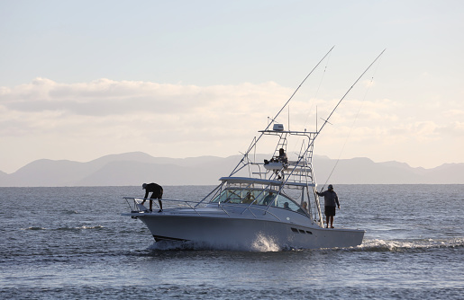 A white fishing boat on a beach on the Sea of Cortez in Mexico. Image taken near Loreto on Coronado Island.