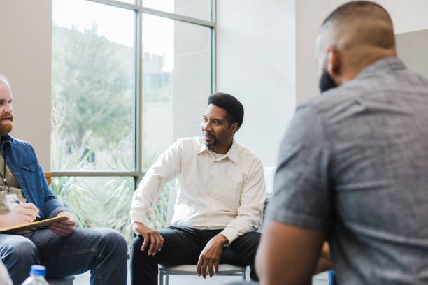 istock Male therapist writes on the clipboard as the group members talk 1451156523