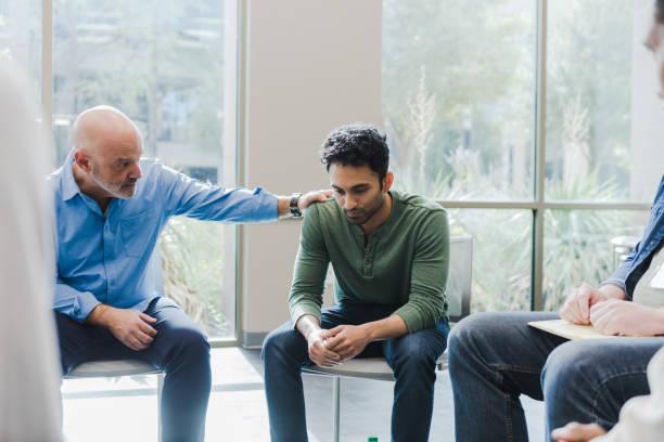 istock Peer places his hand on the young mans shoulder 1451156627