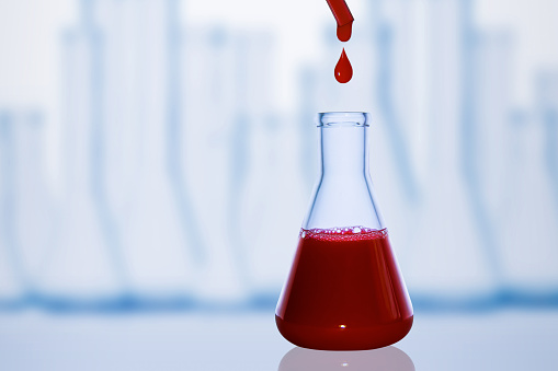 A drop of blood. Pipette. Medical flask with red liquid. Flask with blood. Dripping red liquid. A drop of red. Tests, blood group.