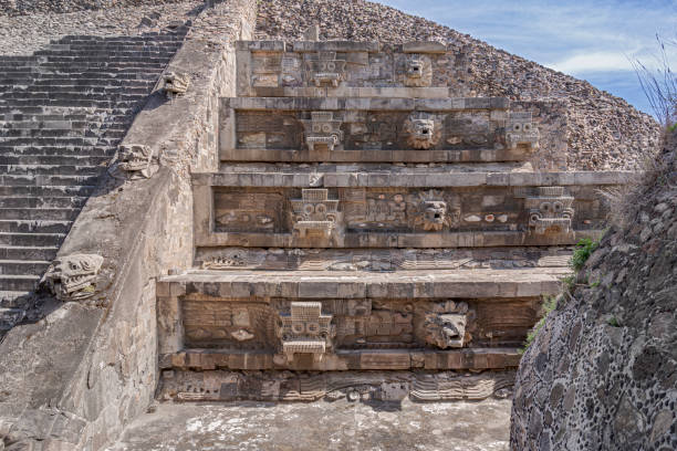 Carved heads depicting feathered snake heads in the Quetzalcoatl temple in Teotihuacan, Mexico. stock photo