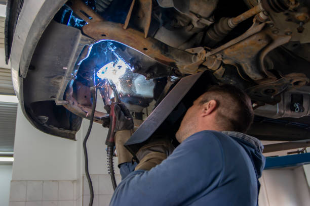 istock Skilled welder with mask doing the welding in a workshop.During the welding, there were a lot of sparks from the iron bar. 1451167294