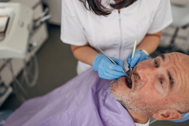 istock Mature man at the dentist 1451177854