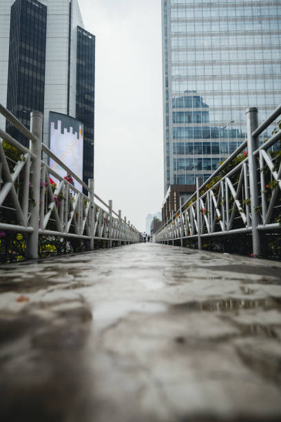 Sudirman pedestrian bridge is empty because after the rain Jakarta, Indonesia - September 2022: Sudirman pedestrian bridge is empty because after the rain business architecture blue people stock pictures, royalty-free photos & images