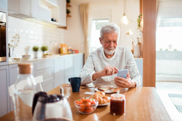 istock Senior man using a phone in the morning 1451180704