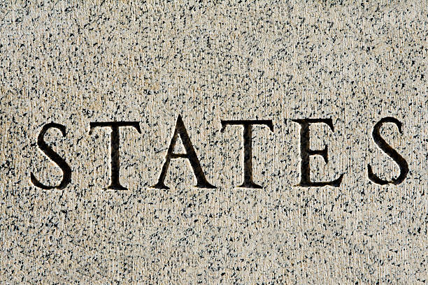 palavra "estado” muito finos esculpidos em granito cinzento - etching tan stone textured imagens e fotografias de stock