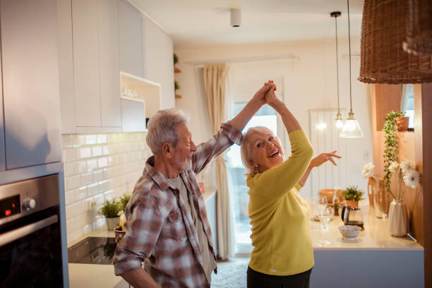 istock Senior couple dancing at home 1451183020