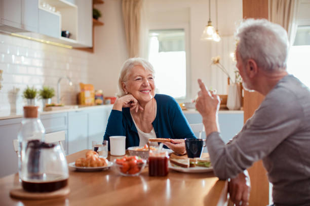 istock Senior couple enjoying breakfast together 1451183292
