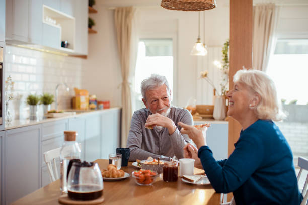 istock Senior couple enjoying breakfast together 1451183406
