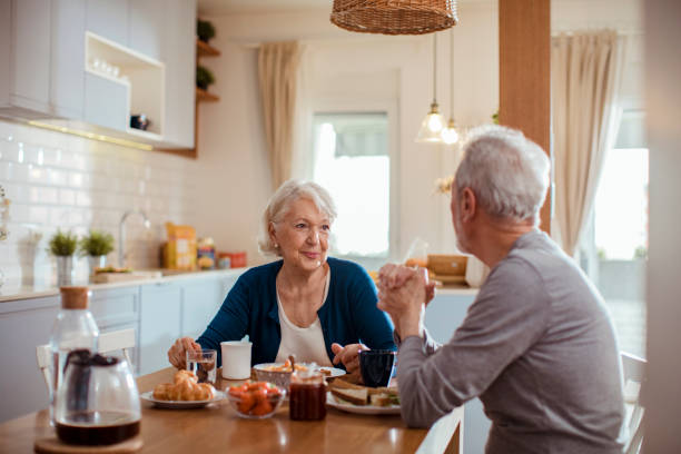 istock Senior couple enjoying breakfast together 1451185479