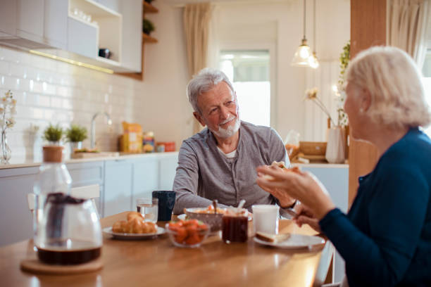 istock Senior couple enjoying breakfast together 1451186337
