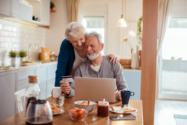 istock Senior couple online shopping 1451187563