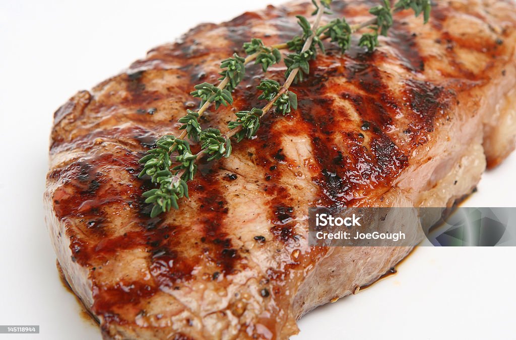 Sirloin Steak Close-up of juicy sirloin steak with thyme garnish Beef Stock Photo