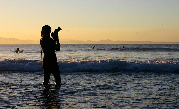 female photographer in wetsuit