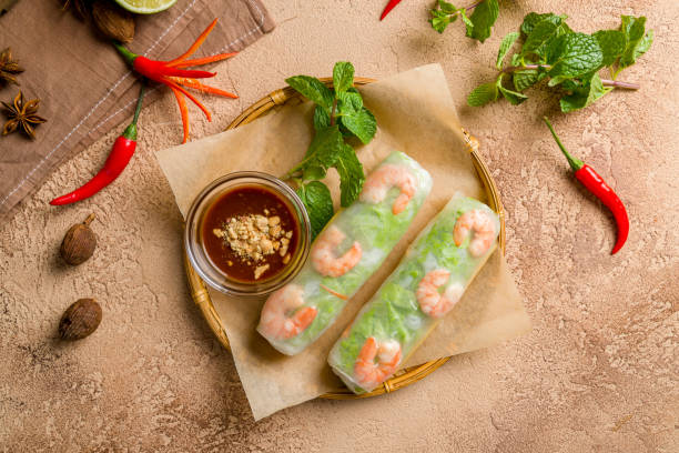 istock Fresh Spring Roll with shrimps, Vietnamese Food top view on brown table 1451201153