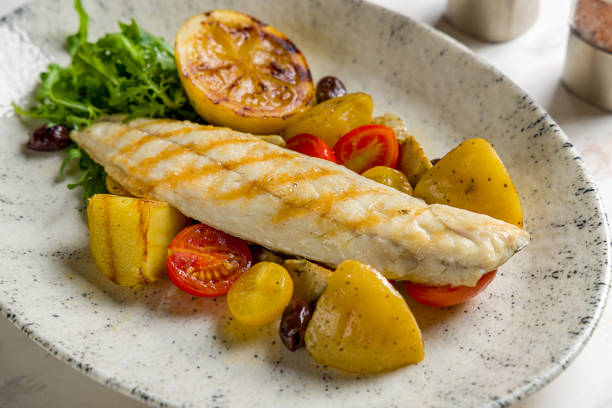 istock sea bass fillet with grilled vegetables and lemon on marble table macro close up 1451201607