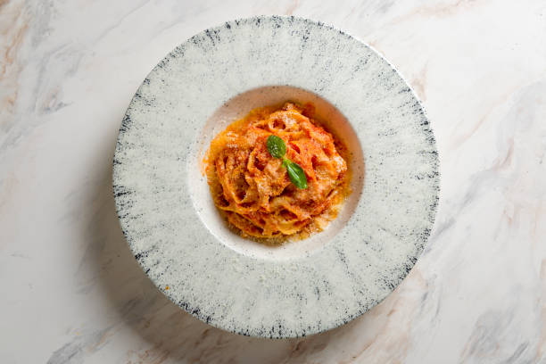istock Tagliatelle al pomodoro with basil on marble table top view 1451202735