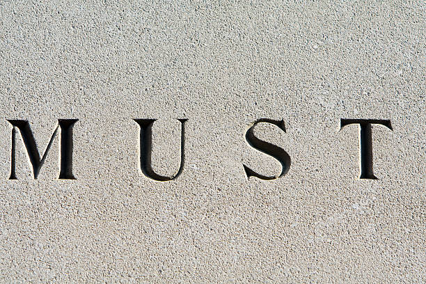 istock Word "Must" Carved in Gray Sandstone 145120773
