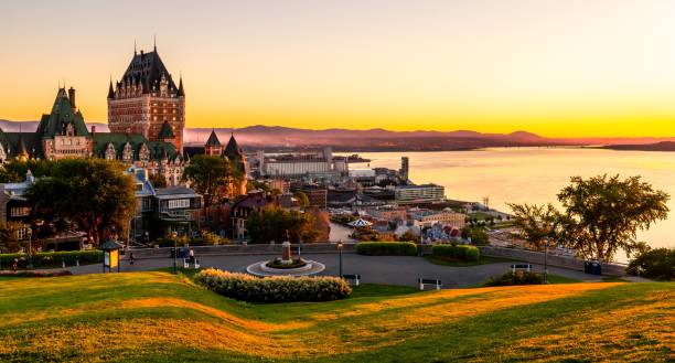 Beautiful view of the Chateau Frontenac surrounded by greenery in Quebec, Canada at sunrise A beautiful view of the Chateau Frontenac surrounded by greenery in Quebec, Canada at sunrise chateau frontenac hotel stock pictures, royalty-free photos & images