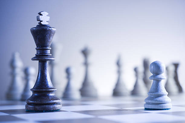 Chessboard featuring king and a pawn with blurred background chess game king chess piece stock pictures, royalty-free photos & images