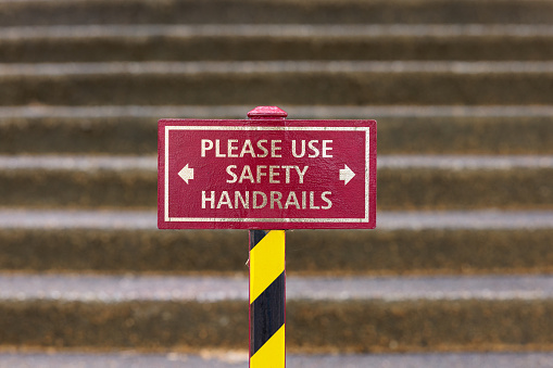 Red safety sign in front of an old staircase.